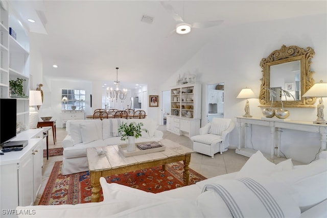 living room with high vaulted ceiling, light tile patterned floors, and ceiling fan with notable chandelier