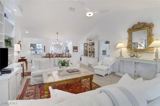 living room with vaulted ceiling, ceiling fan with notable chandelier, visible vents, and light tile patterned floors