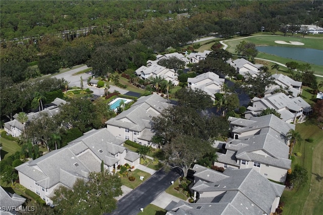 birds eye view of property with a wooded view, a residential view, a water view, and view of golf course