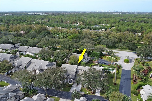 drone / aerial view with a residential view and a wooded view