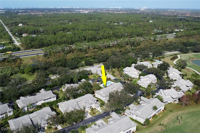 bird's eye view featuring a wooded view, a residential view, and golf course view