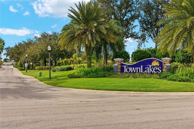 community / neighborhood sign with a lawn