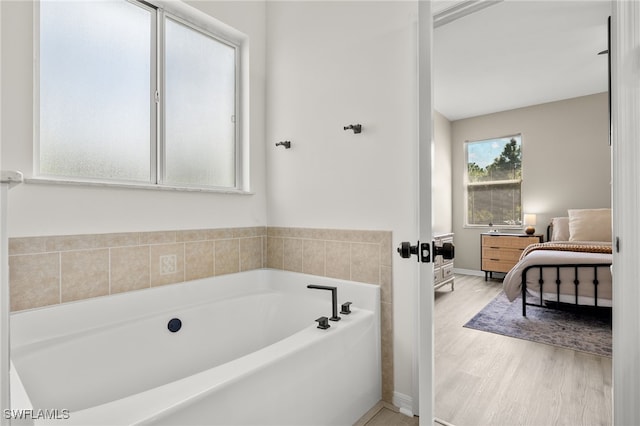 bathroom with a bathing tub and wood-type flooring