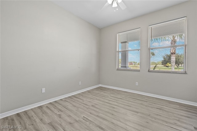 spare room with light wood-type flooring and ceiling fan