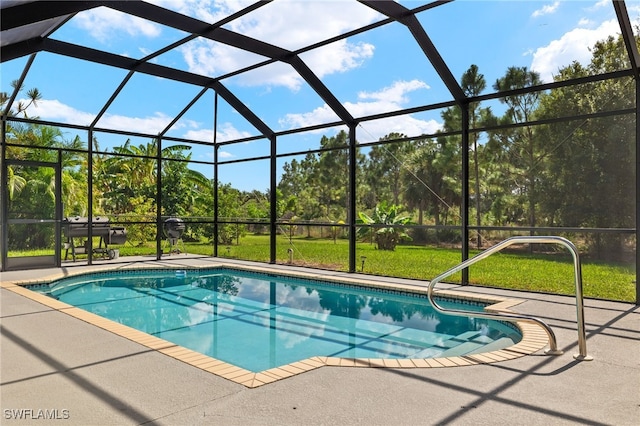 view of pool with a patio and glass enclosure