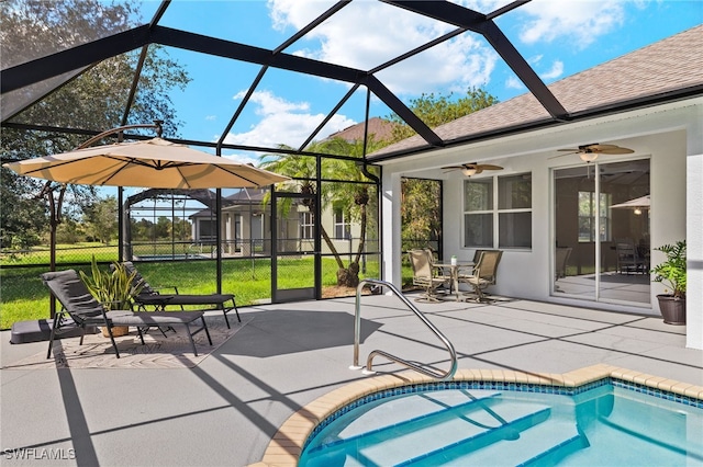 exterior space featuring a patio area, a lanai, ceiling fan, a storage shed, and a lawn