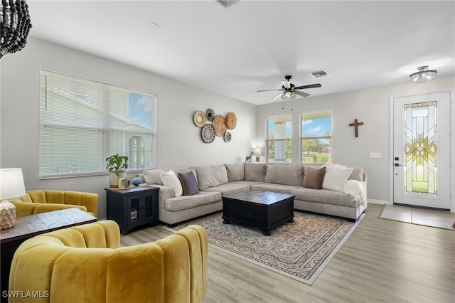 living room featuring light wood-type flooring and ceiling fan