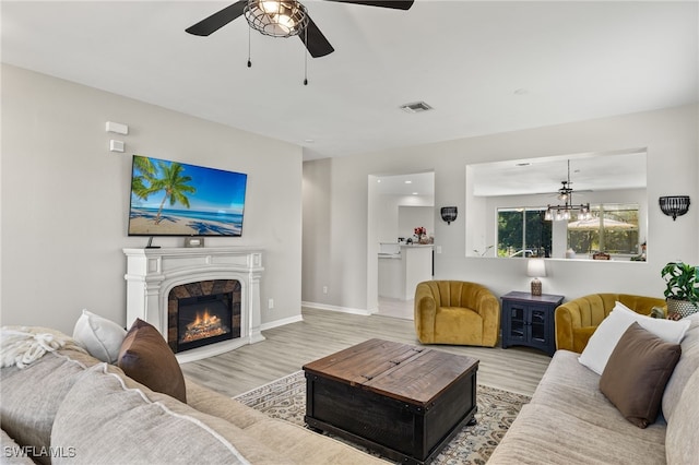 living room featuring ceiling fan and light wood-type flooring