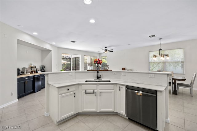 kitchen featuring an island with sink, white cabinetry, dishwasher, pendant lighting, and sink