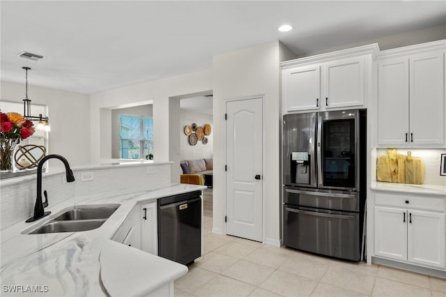 kitchen featuring white cabinets, dishwasher, and stainless steel fridge