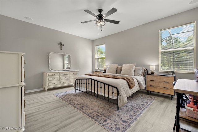 bedroom with light hardwood / wood-style flooring and ceiling fan