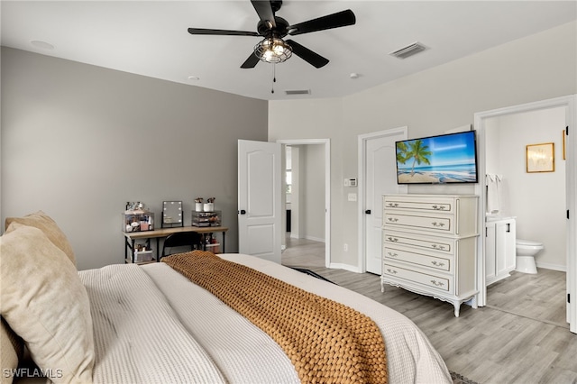 bedroom featuring ensuite bathroom, light hardwood / wood-style floors, and ceiling fan