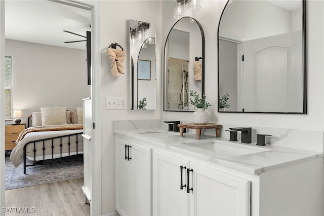 bathroom featuring vanity, hardwood / wood-style flooring, and ceiling fan