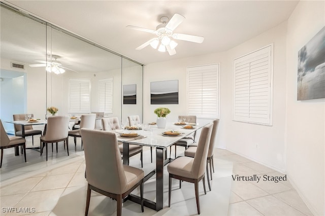 dining area featuring light tile patterned floors, baseboards, visible vents, and a ceiling fan