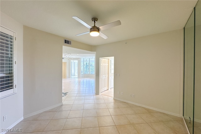 tiled empty room with ceiling fan