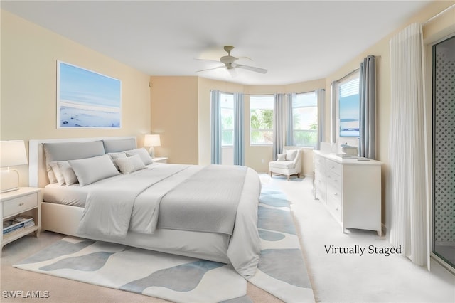 bedroom featuring ceiling fan and light colored carpet