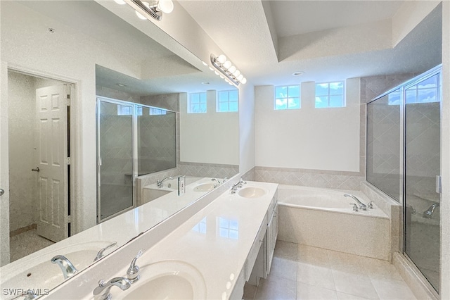 bathroom featuring independent shower and bath, vanity, a textured ceiling, and tile patterned flooring