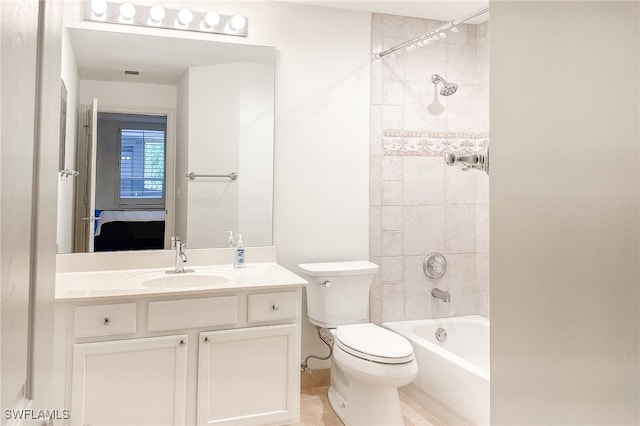 full bathroom featuring tile patterned flooring, vanity, toilet, and tiled shower / bath