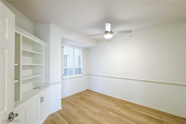 empty room featuring light wood-type flooring, ceiling fan, and baseboards