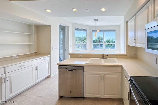 kitchen with open shelves, appliances with stainless steel finishes, a sink, and recessed lighting