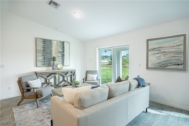 living room featuring vaulted ceiling and hardwood / wood-style floors