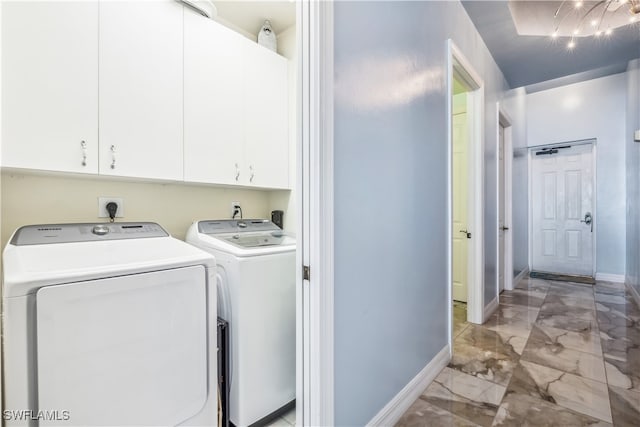 clothes washing area with independent washer and dryer and cabinets