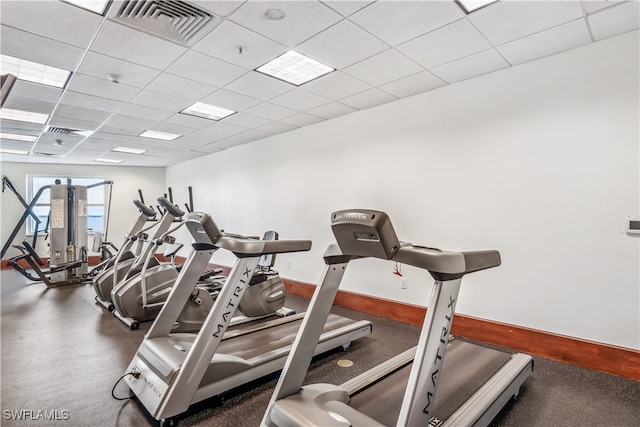 workout area with a paneled ceiling