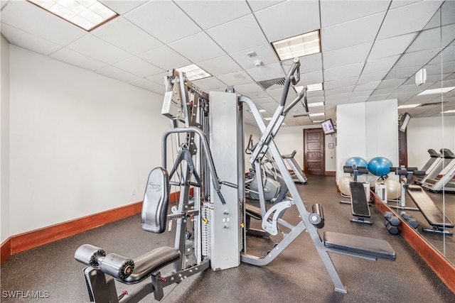 gym with a paneled ceiling