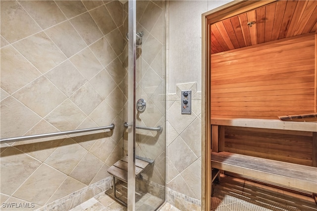 bathroom with wooden ceiling and tiled shower