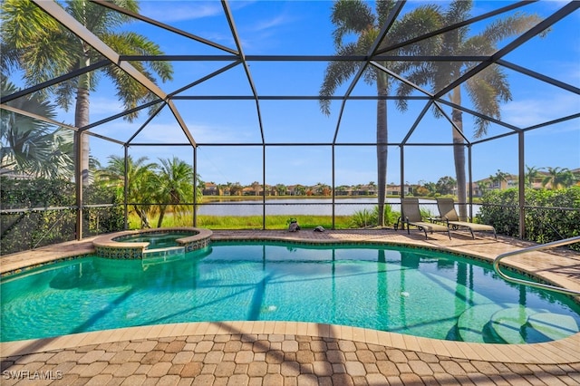 view of pool with an in ground hot tub, a water view, and glass enclosure