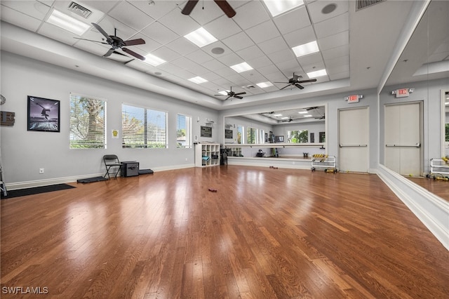 exercise area with a drop ceiling and wood-type flooring