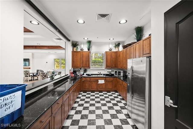 11309 Pond Cypress St, Fort Myers, FL 33913 - kitchen featuring stainless steel fridge, a sink, recessed lighting, brown cabinetry, and dark flooring