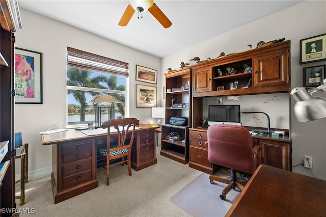 carpeted office with ceiling fan