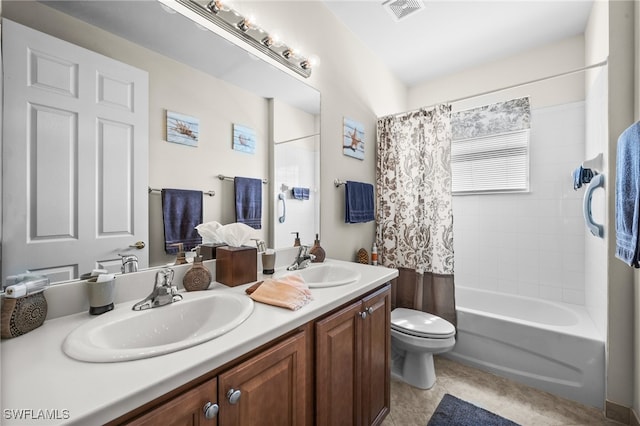 full bathroom with vanity, shower / bath combo with shower curtain, toilet, and tile patterned flooring