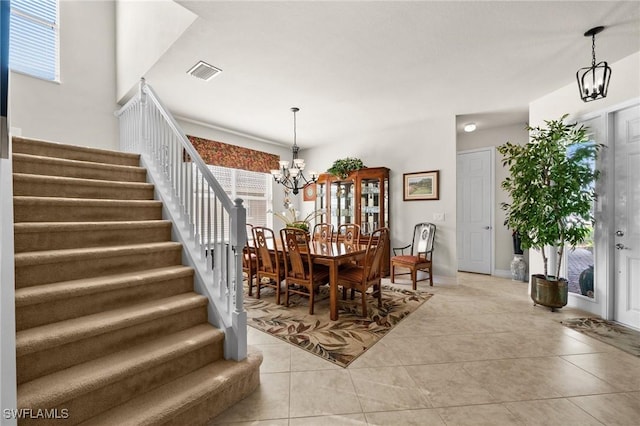 11309 Pond Cypress St, Fort Myers, FL 33913 - dining area with a chandelier, stairway, and light tile patterned floors