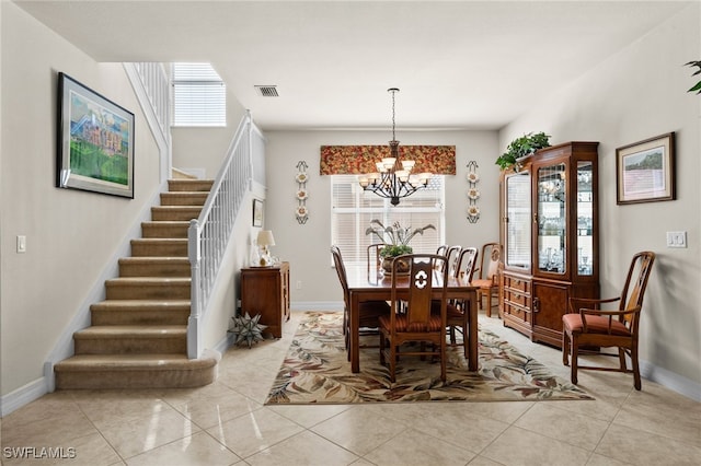 dining room with a chandelier and light tile patterned floors