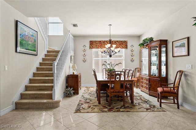 11309 Pond Cypress St, Fort Myers, FL 33913 - dining space with a chandelier, stairway, baseboards, and light tile patterned floors