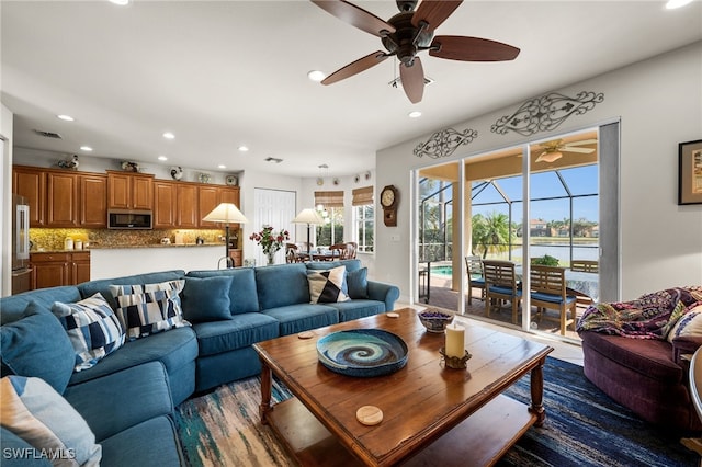 living area featuring visible vents, recessed lighting, and a ceiling fan