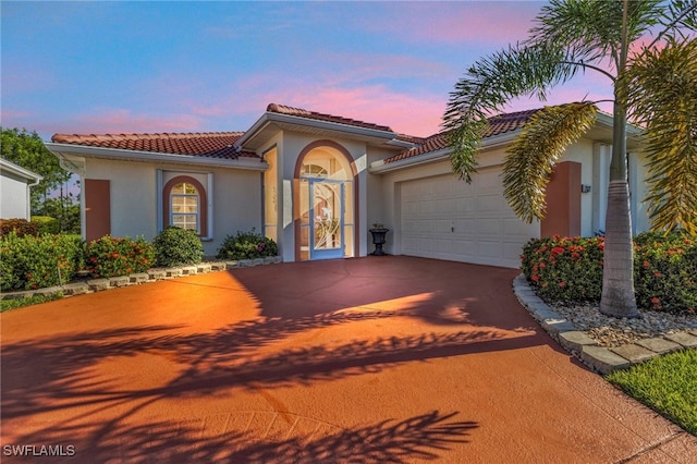 mediterranean / spanish-style house with a garage