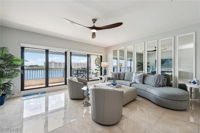 living room featuring a water view and ceiling fan