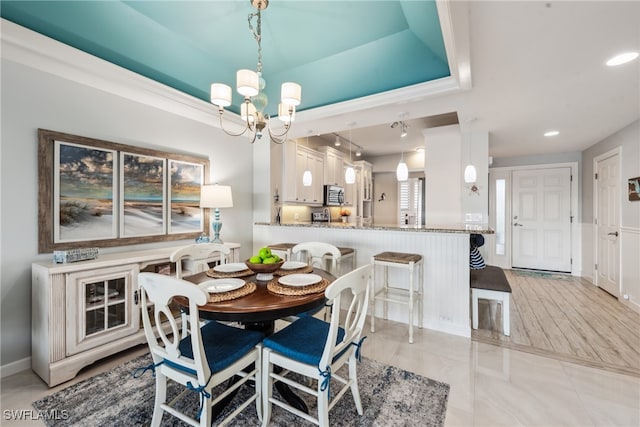 dining room featuring a tray ceiling and a chandelier