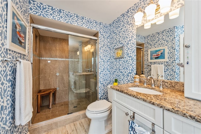 bathroom featuring vanity, toilet, and walk in shower