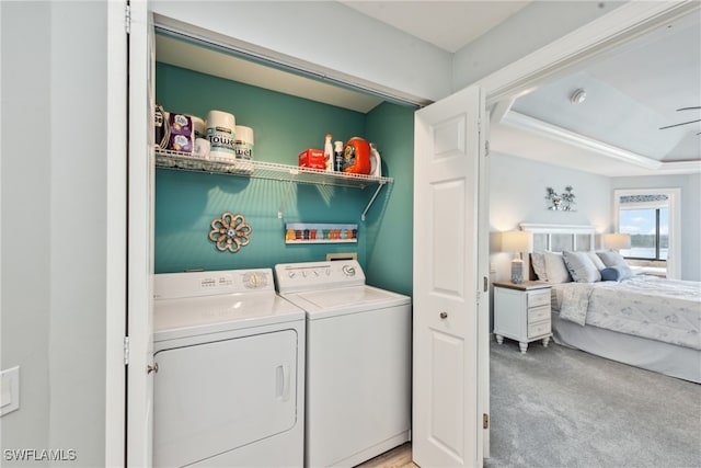 washroom featuring separate washer and dryer and light colored carpet