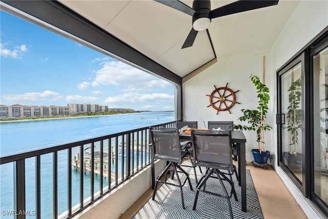 balcony featuring ceiling fan and a water view