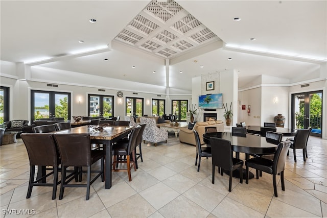 dining room featuring lofted ceiling, french doors, and plenty of natural light