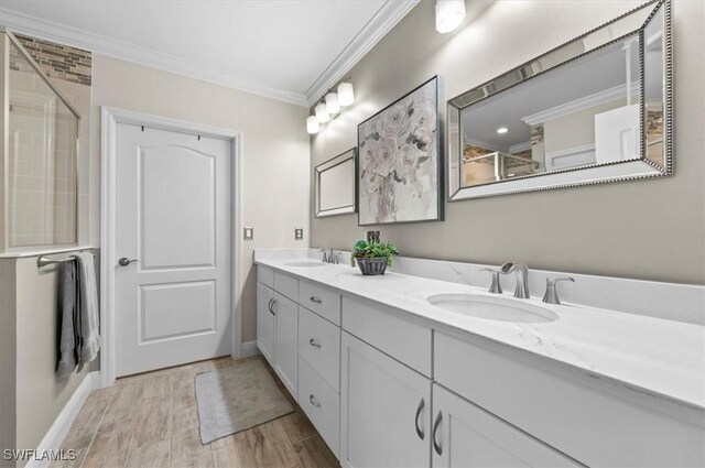 bathroom featuring vanity, crown molding, and walk in shower