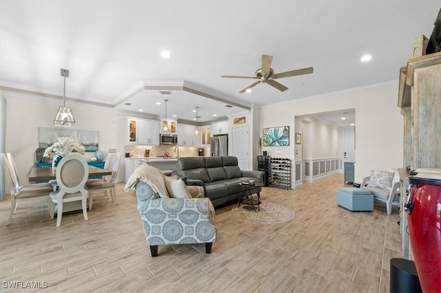 living room with ceiling fan and crown molding