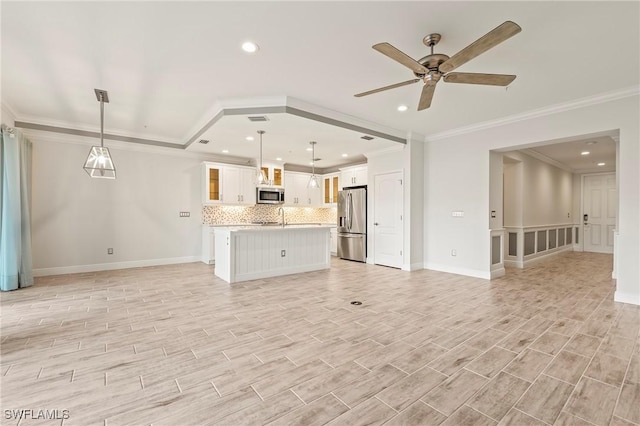 unfurnished living room featuring ceiling fan, light hardwood / wood-style floors, sink, and crown molding