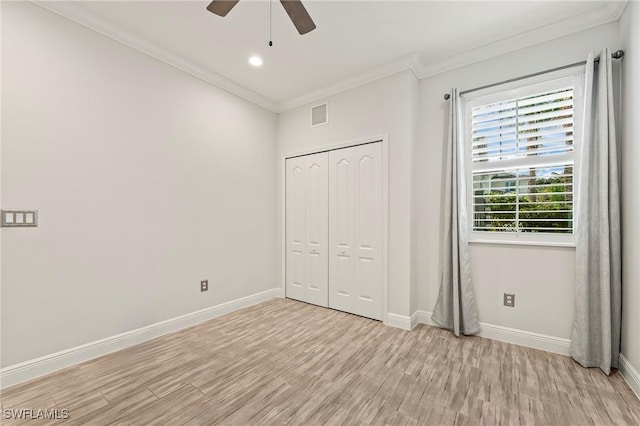 unfurnished bedroom with ceiling fan, a closet, crown molding, and light hardwood / wood-style flooring