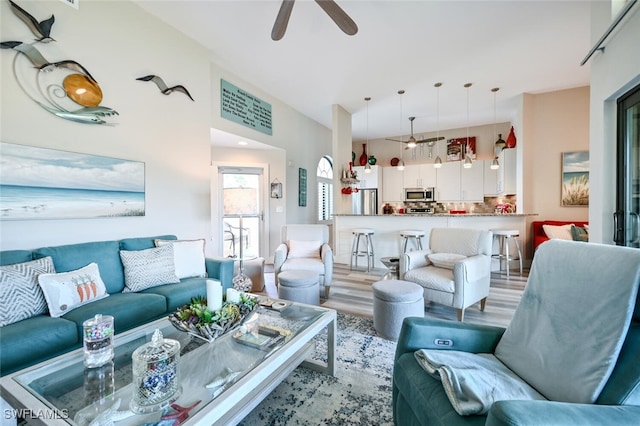 living room featuring ceiling fan and light hardwood / wood-style floors